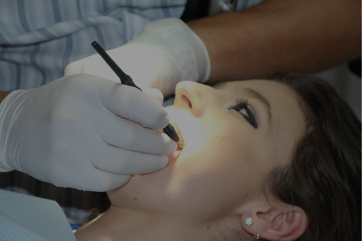 Dentist examining a patient with an intraoral camera
